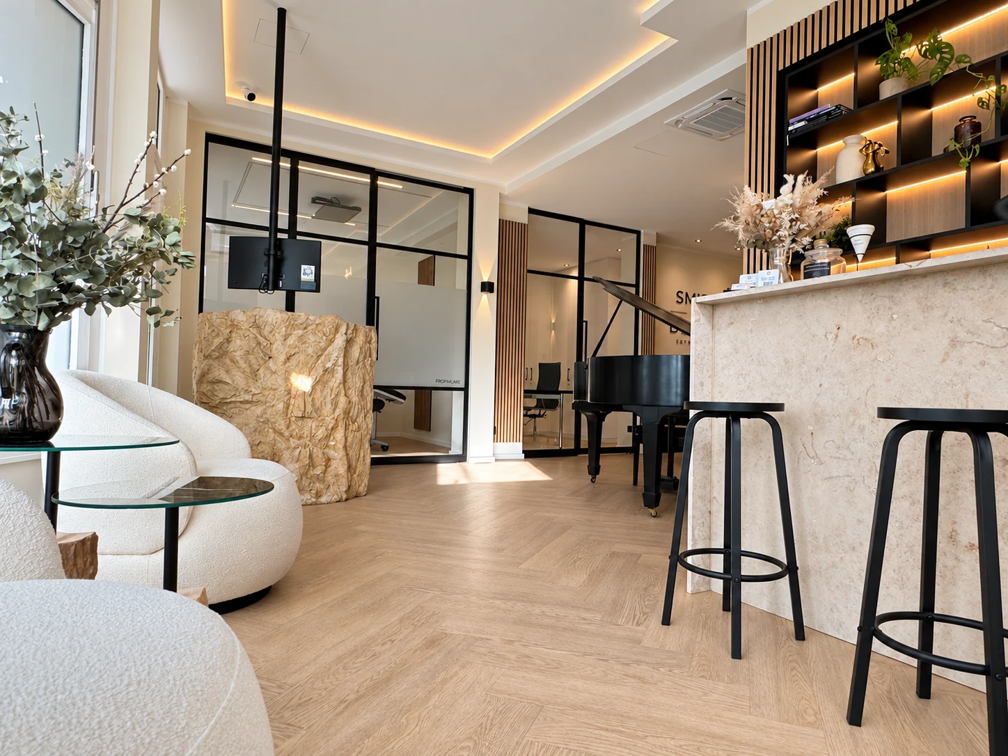 Lounge with marble counter, illuminated shelving and grand piano